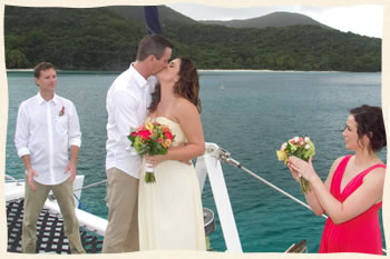 Just married couple sealing it with a kiss sailboat wedding.